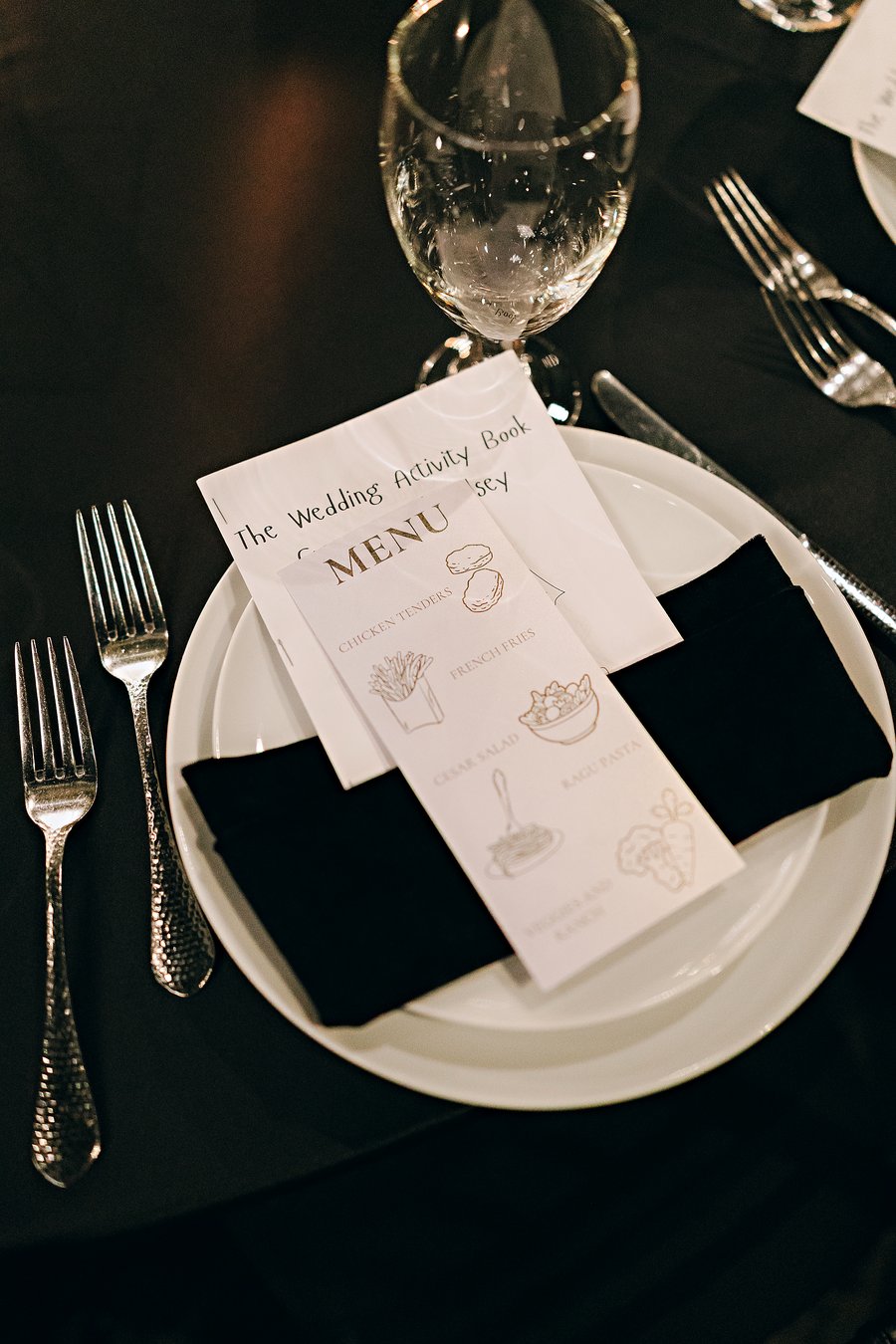 Kids menu and wedding activity book on a place setting