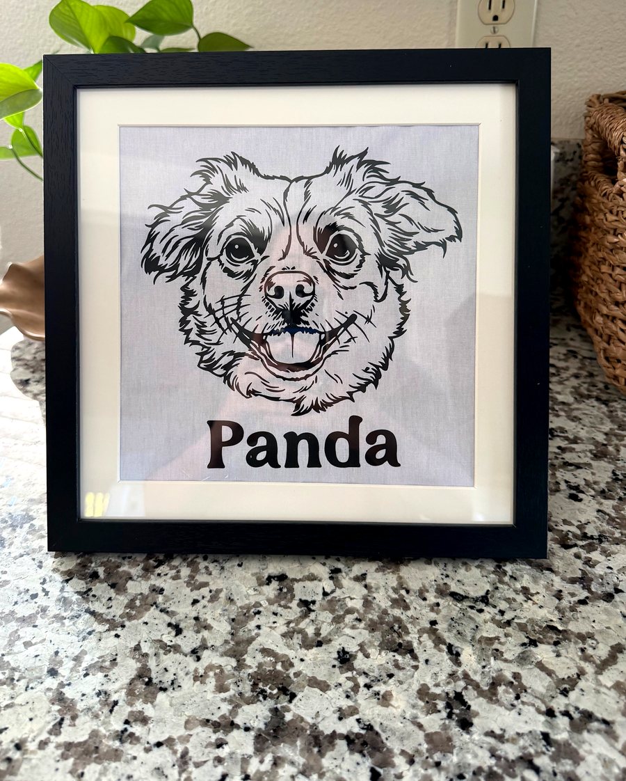 Framed custom pet portrait printed on fabric showing a dog named Panda