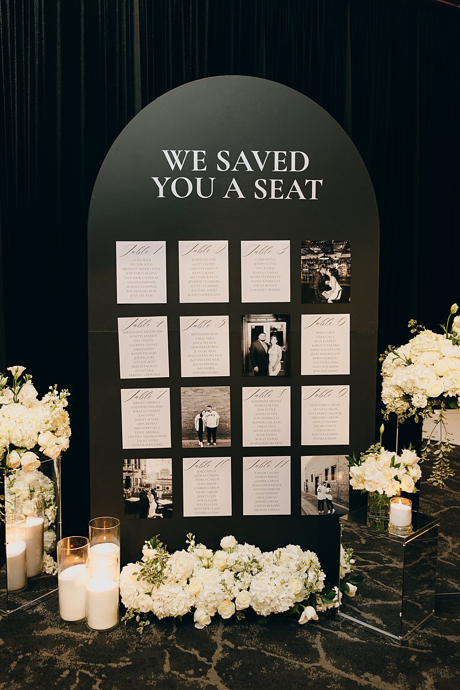 We Saved You a Seat wedding seating chart with table cards, photos, candles and white florals
